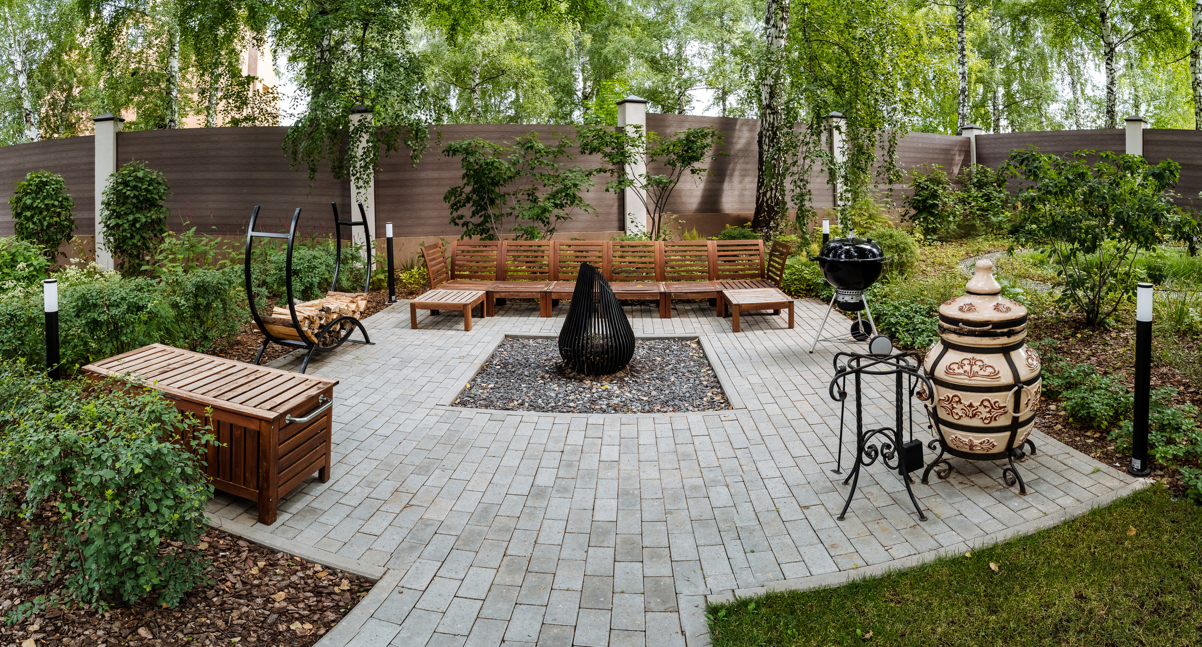Luxury outdoor patio with stone pavers and elegant furniture